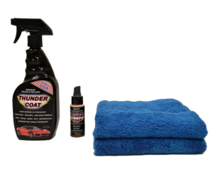 Car care products including spray, liquid bottle, and blue microfiber towels.
